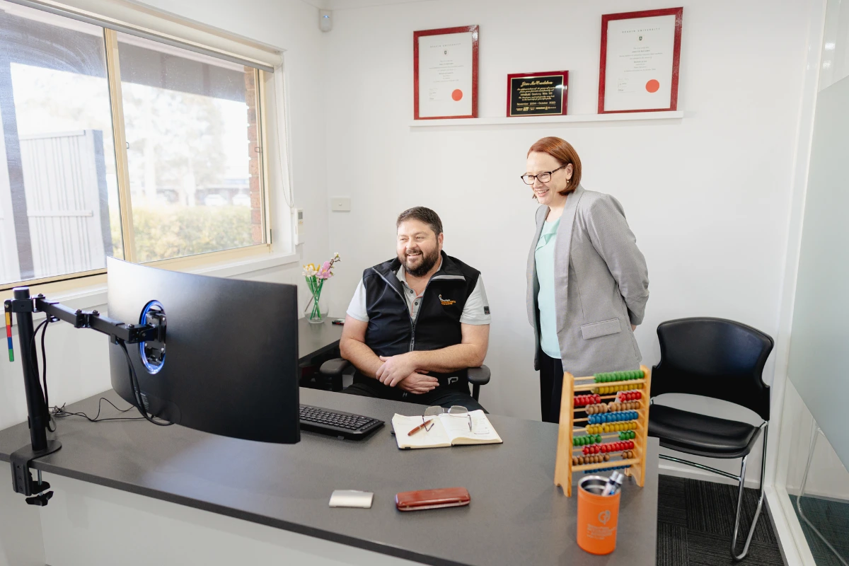 Jim and Teresa McCredden reviewing client data at Golden Plains Accountants for strategic financial insights